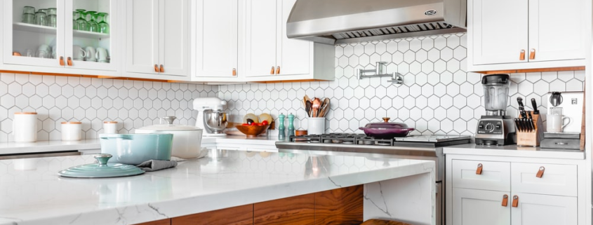 a modern kitchen with brown accessories and accents