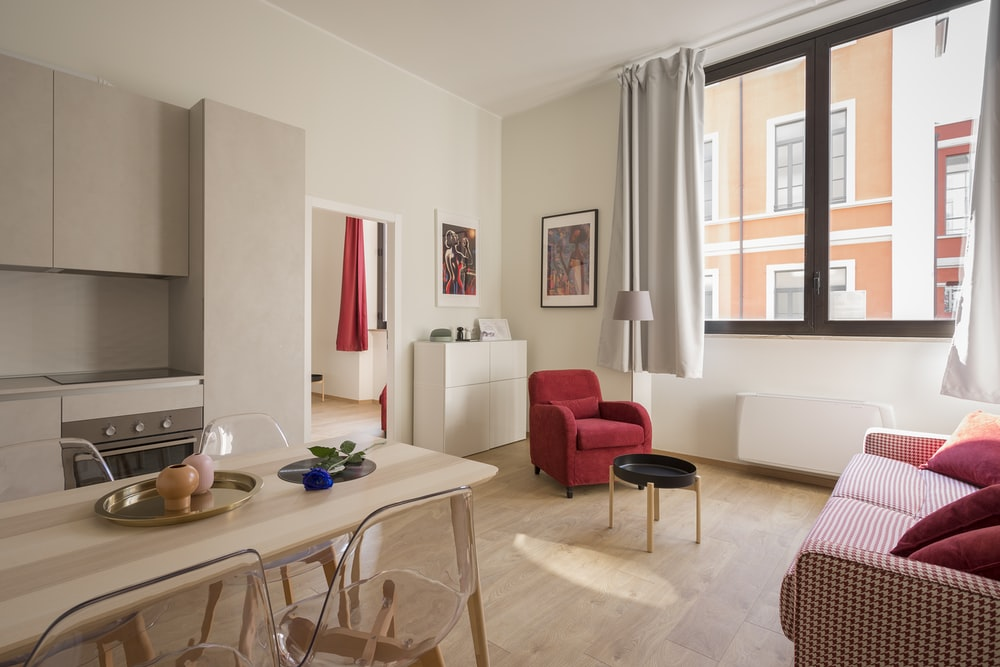 a modern living room with crimson furnishings and accents