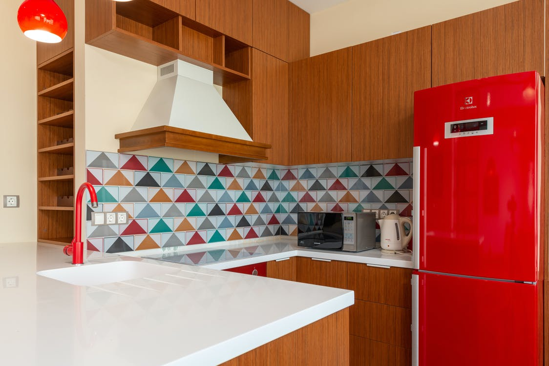 A kitchen with wooden cabinets