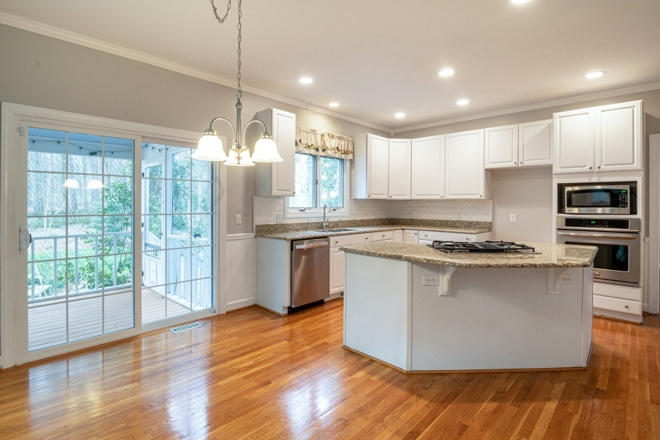 A kitchen with shiny wooden flooring