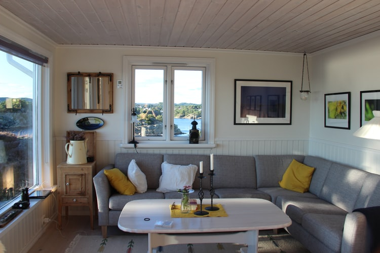 Living room with an L-shaped grey sofa and wall decor